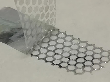 Hologram sticker with honeycomb reveal pattern