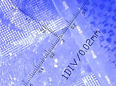 hologram sticker with nano-text under microscope showing text 0.02mm high