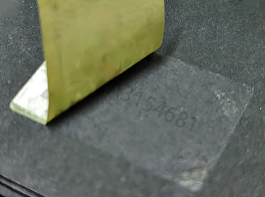 Paper label peeling off to reveal numbering